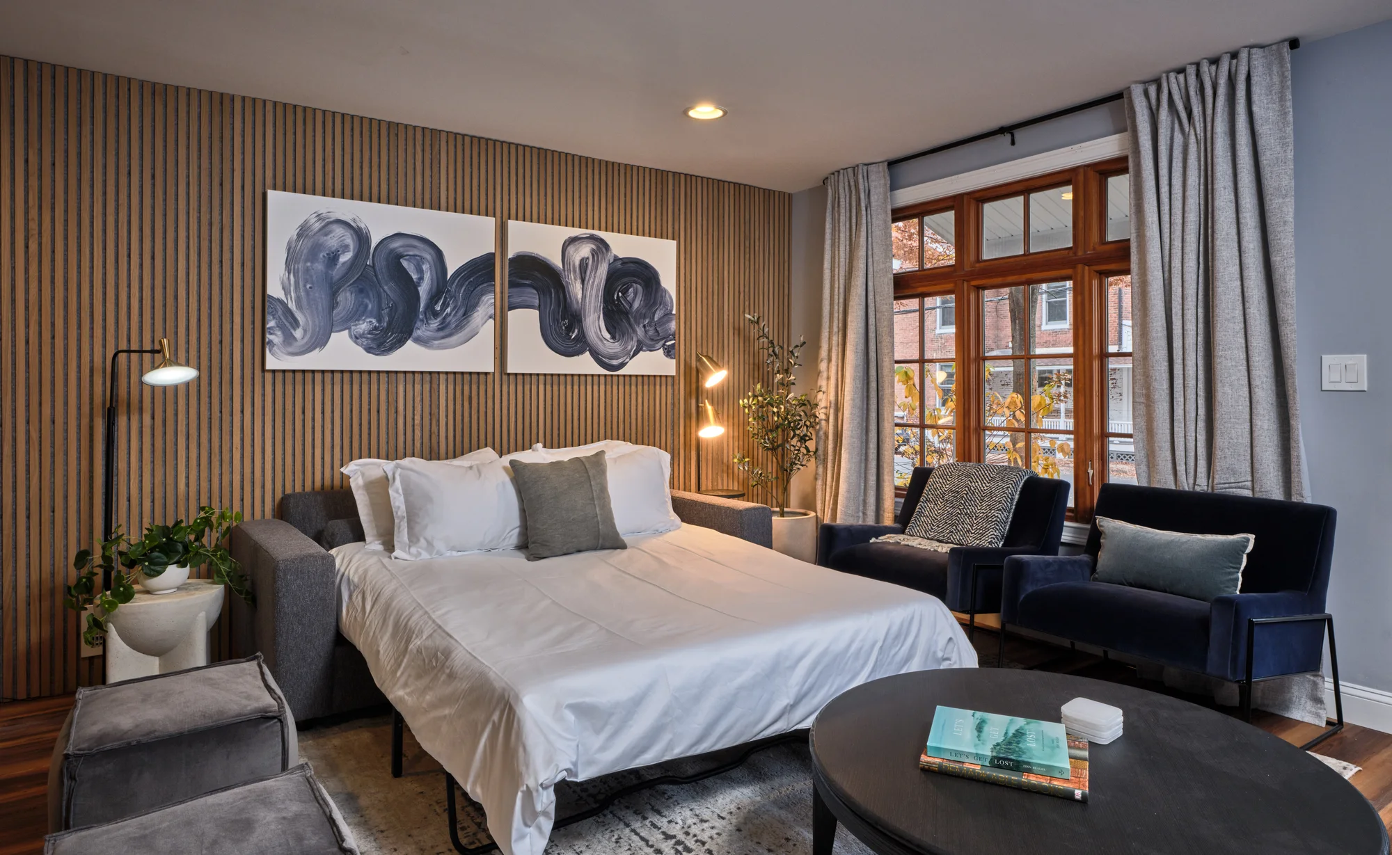Bedroom with wood accent wall — The Lambertville Haven