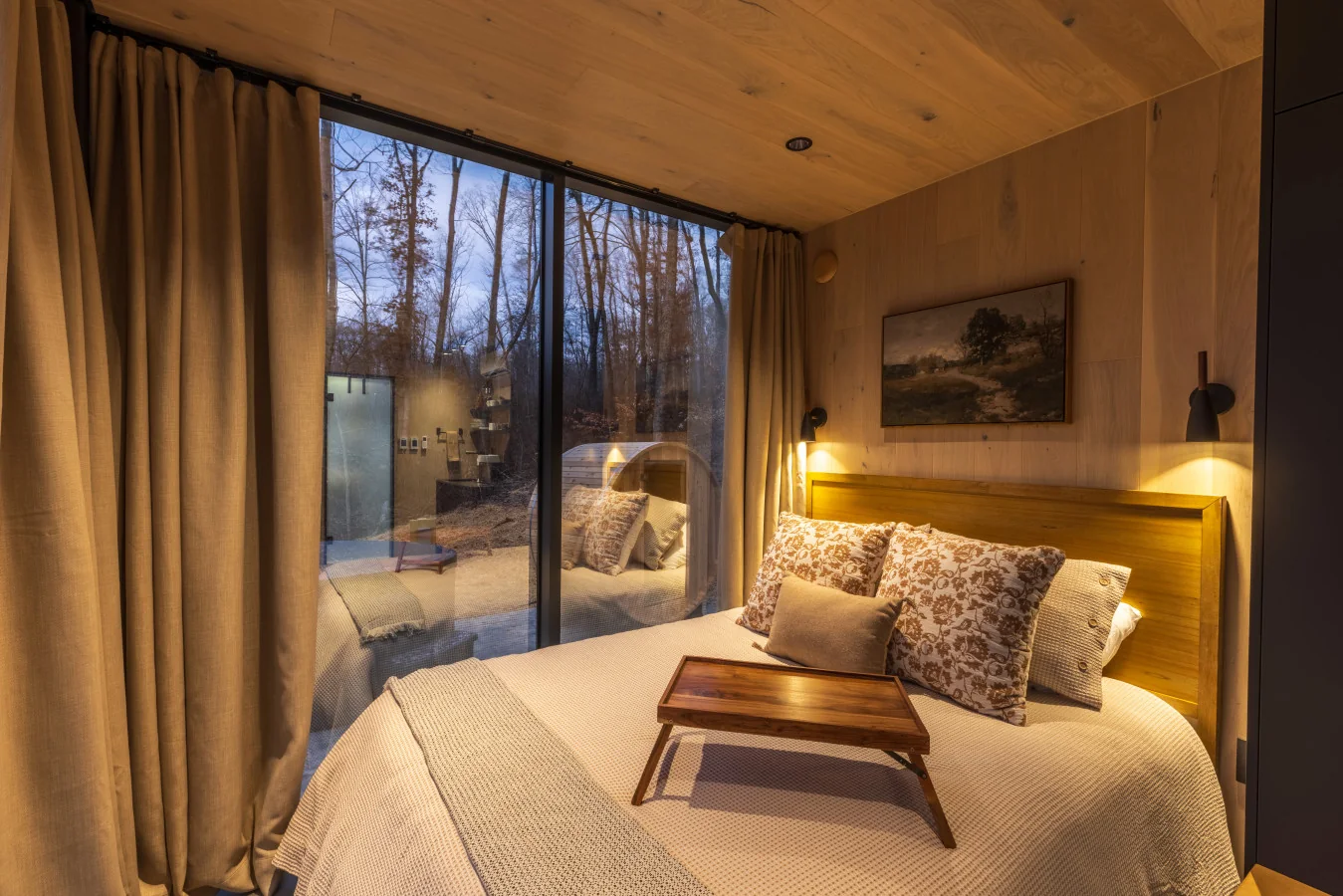 Earth-tone bedroom with forest view — The Mirage Escape