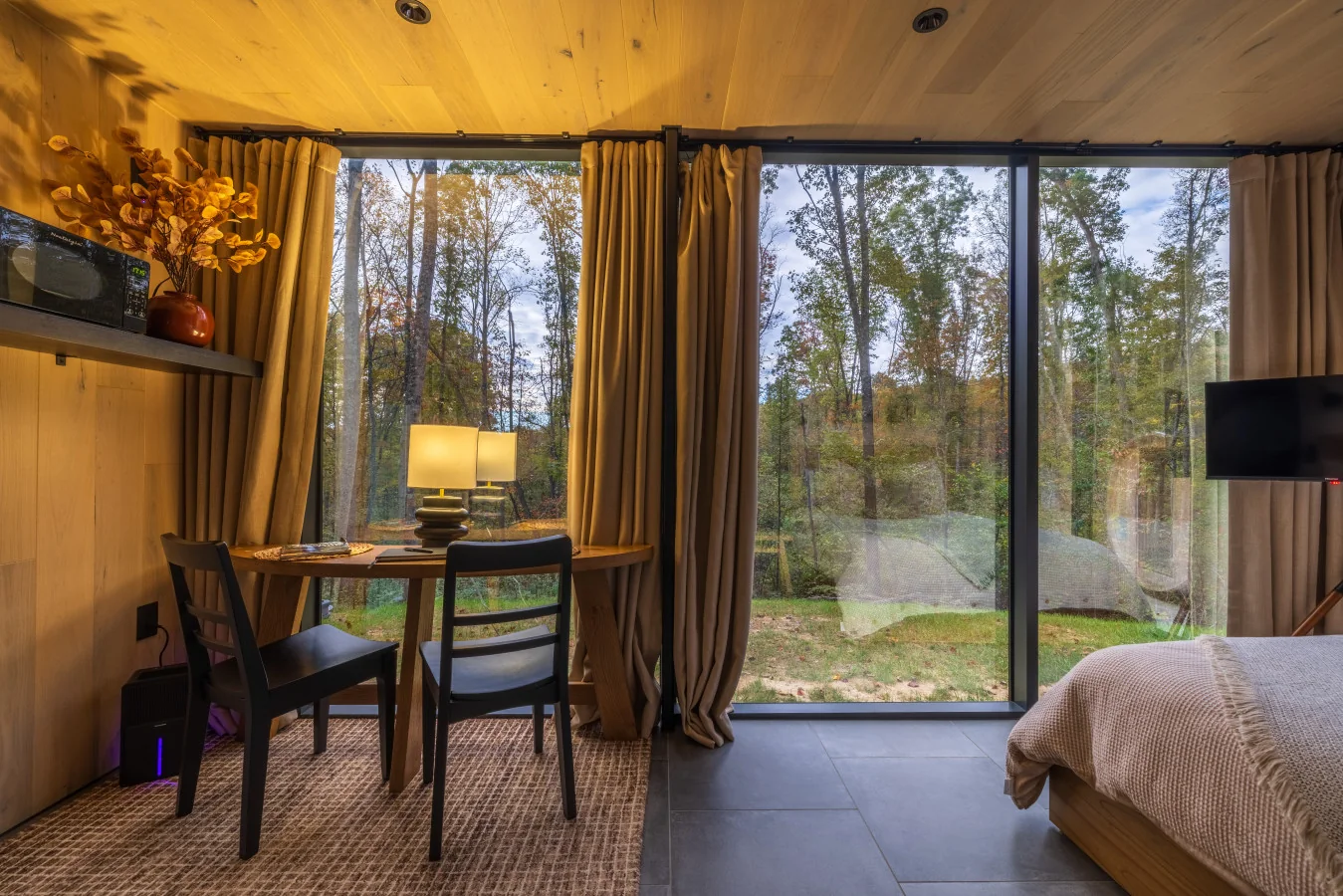 Bedroom with forest windows — The Mirage Escape